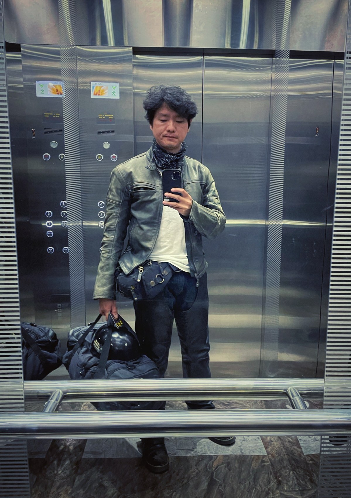 Wearing chaps with a riding jacket, trousers and boots.